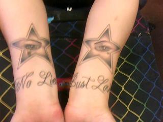 star with crying eye and quote no lies just love tattoo on wrist