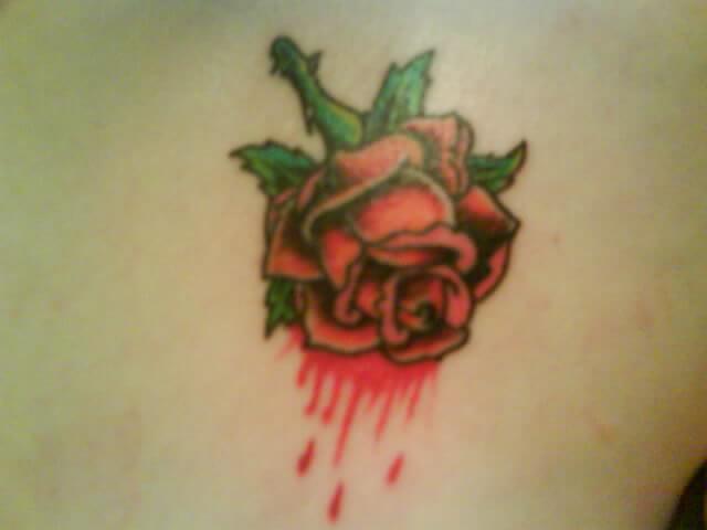 tiny red rose bleeding tattoo design