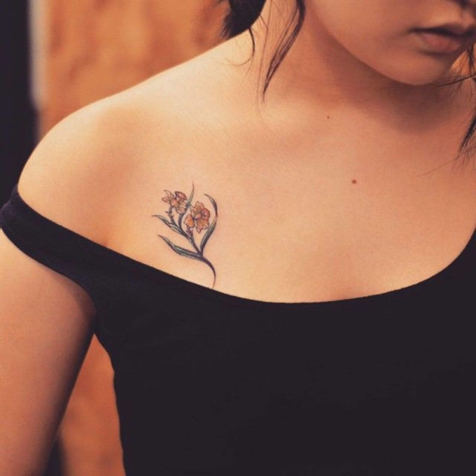 december birth flower narcissus tattoo on collarbone