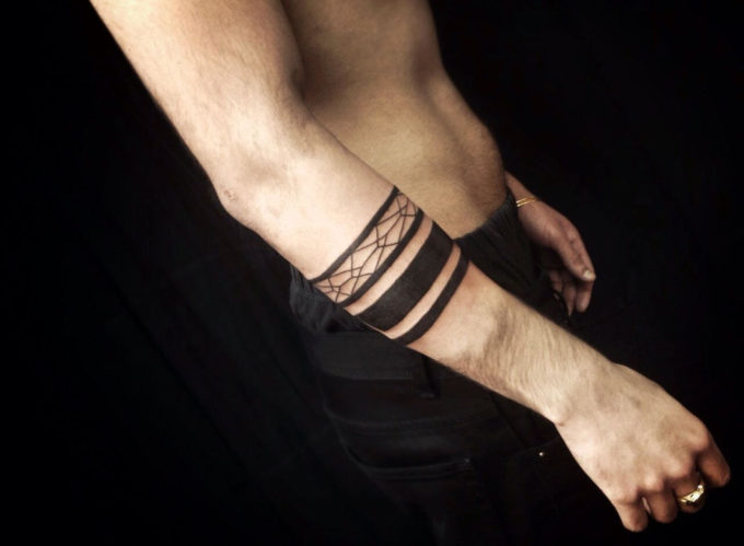 abstract pattern black band tattoo design idea on forearm for men