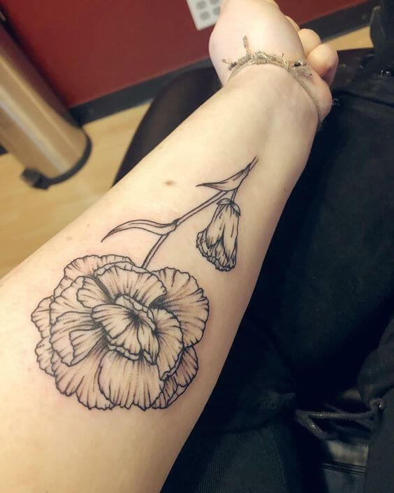 big black and white carnation January birth flower tattoo design on forearm