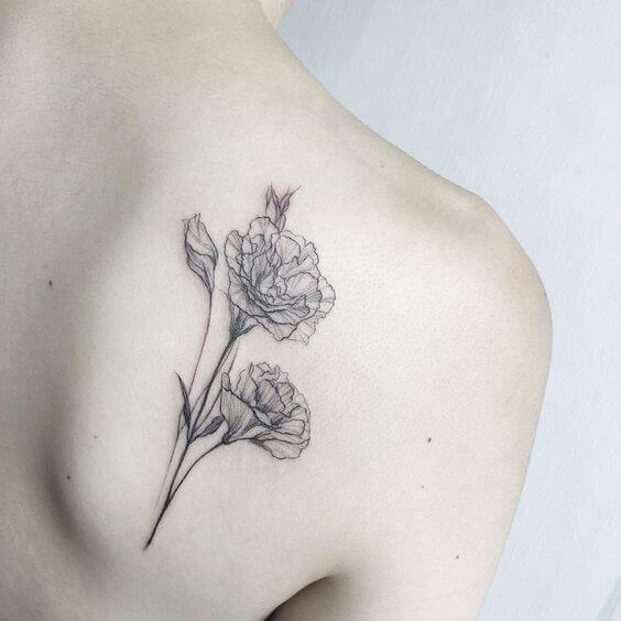 black and grey carnation January birth flowers tattoo on shoulder blade