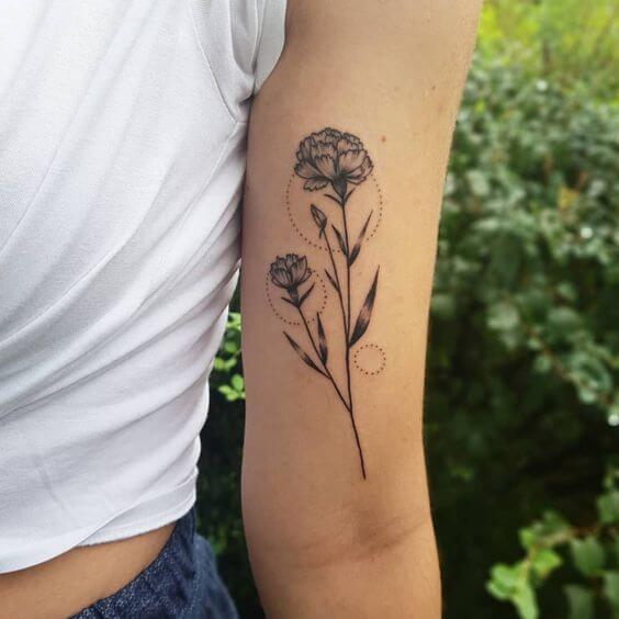 carnation January birth flower with dotted rings tattoo on upper arm