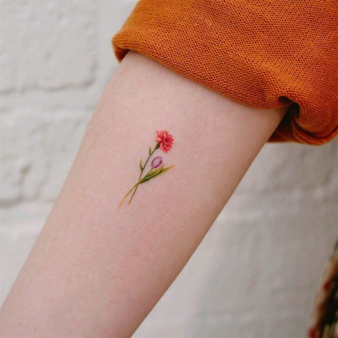 tiny blooming carnation January birth flower bud tattoo design