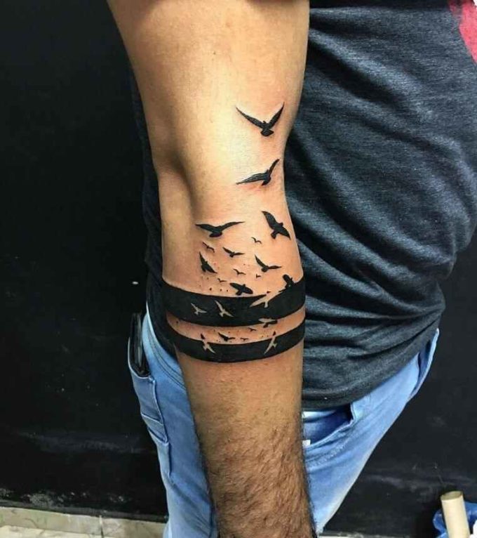 free flying birds out of black bands tattoo design on arm for men