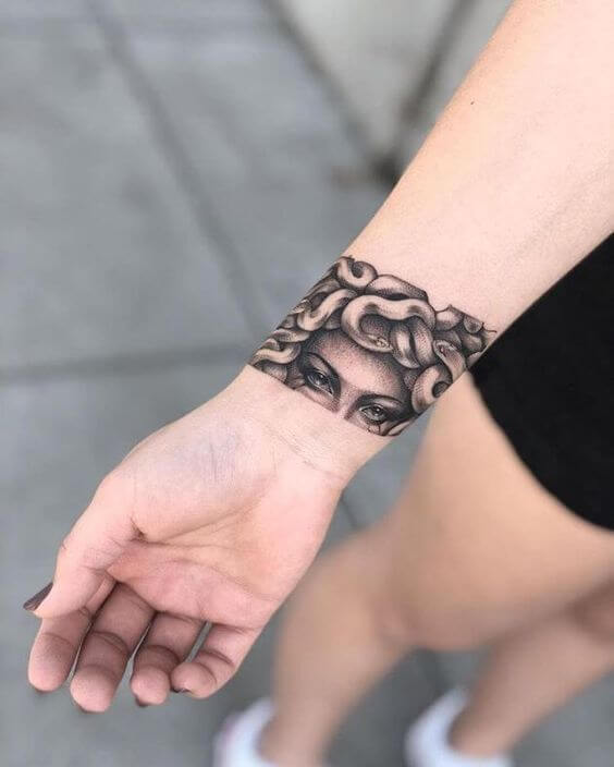 greek medusa black band wrist tattoo design for females