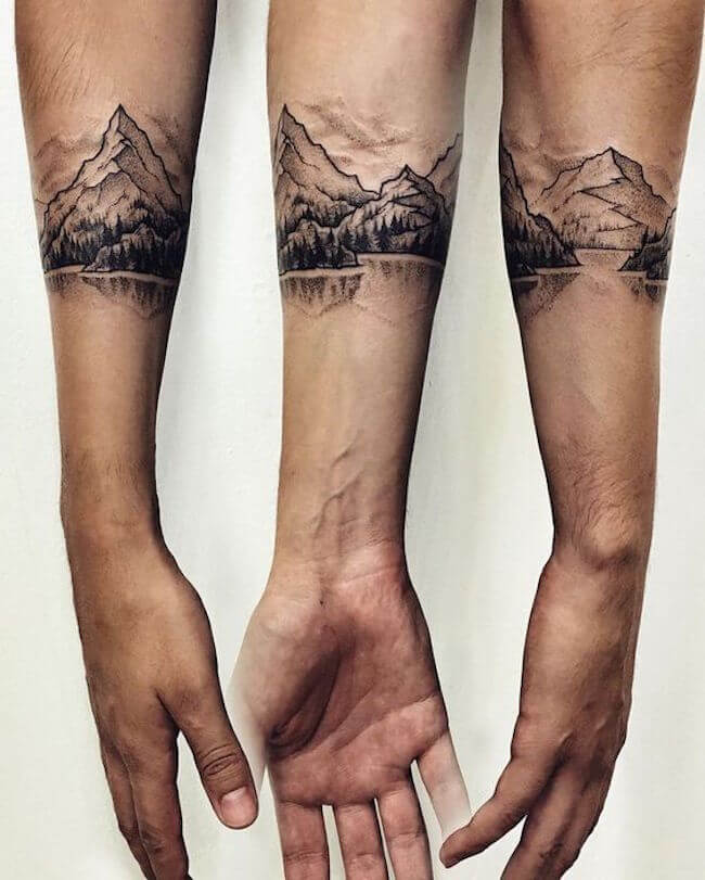 mountain range band tattoo design on forearm