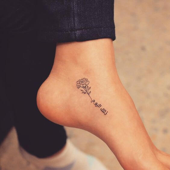 small carnation January birth flower with Arabic signature tattoo on foot