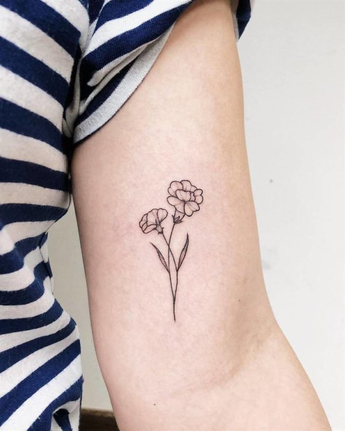 black and white carnation January birth flower tattoos on arm