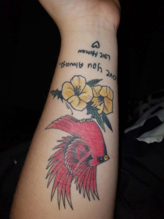 angry bird with primroses and love text tattoo design on wrist