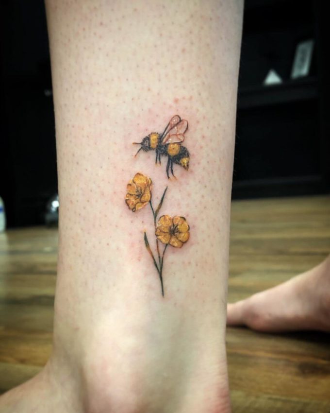 fuzzy bumblebee and primrose tattoo design on ankle