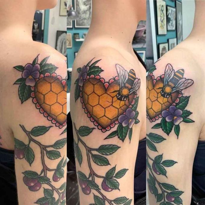 honey cells with bees and violets branch tattoo design on upper arm