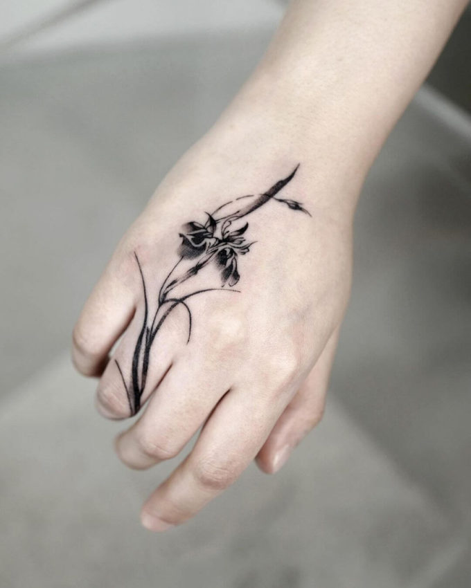iris floral tattoo on hand