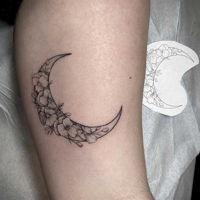 white violet flowers in outlined crescent moon tattoo design