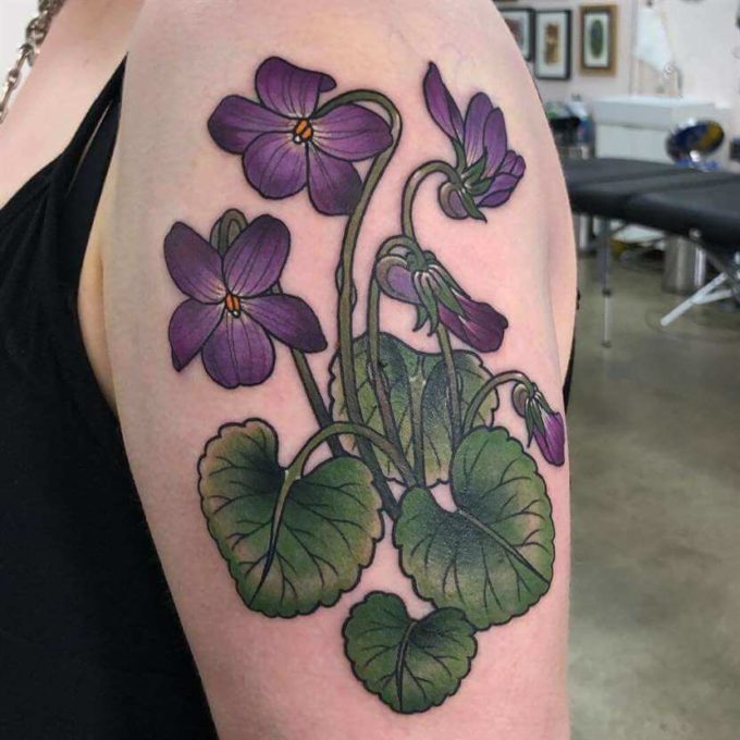 violet flowers with leaves tattoo design on upper arm