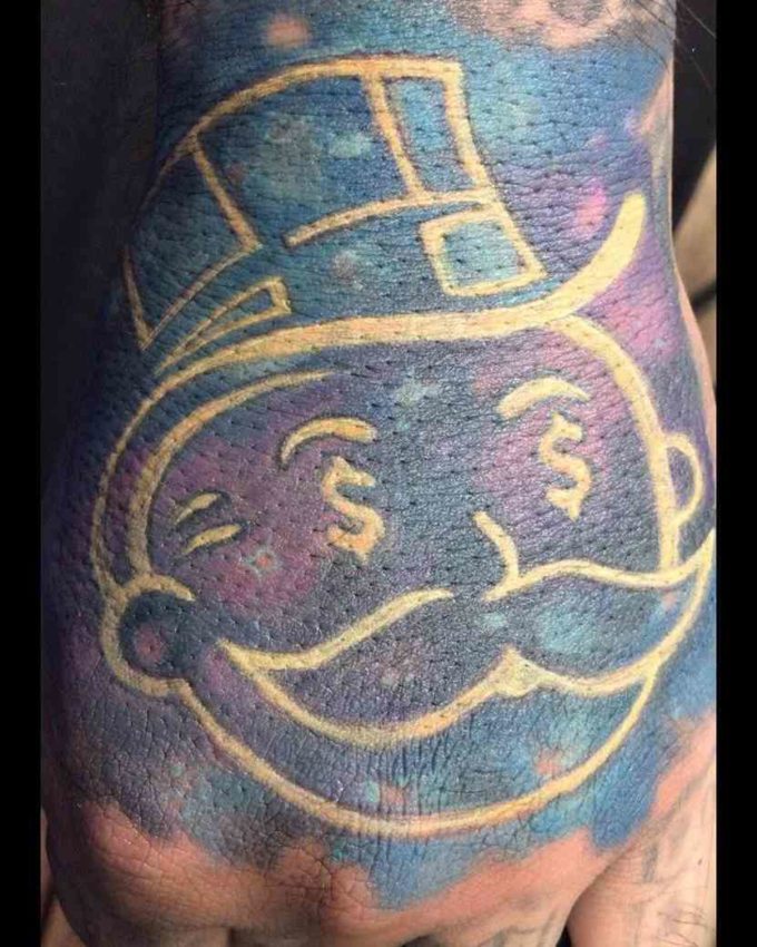 golden ink monopoly man head tattoo design on hand for men