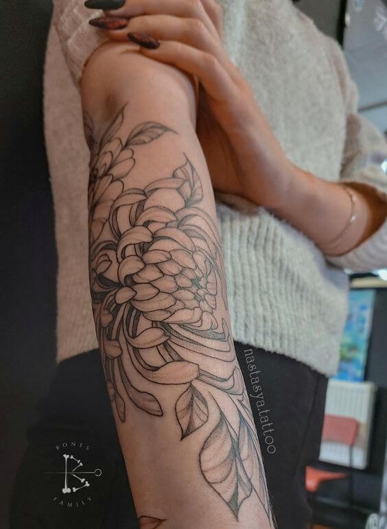 simple november birth flower tattoo design on lower arm
