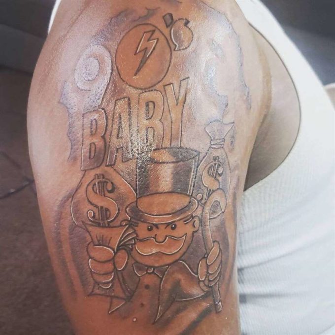 monopoly man with money bags upper sleeve tattoo design for black men