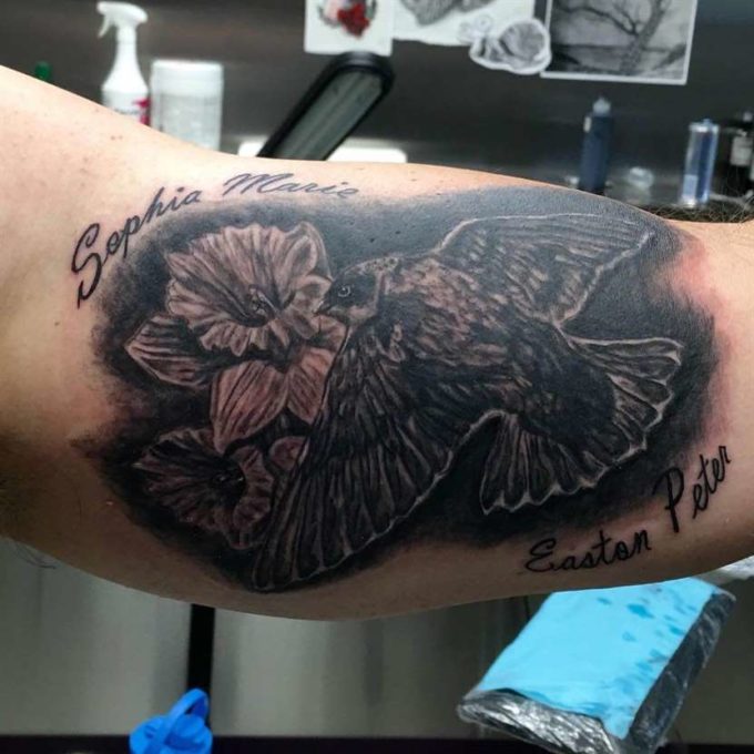 black and grey sparrow with daffodils tattoo design idea for march