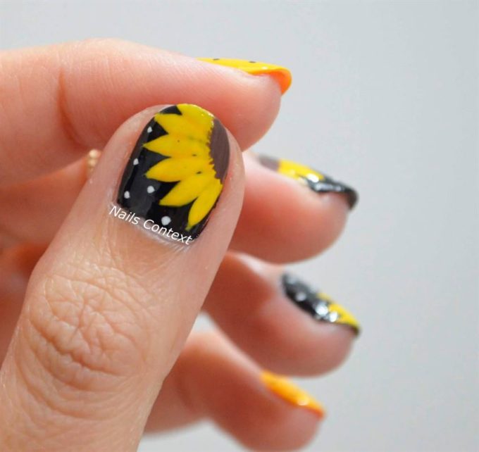 black nails with sunflower designs