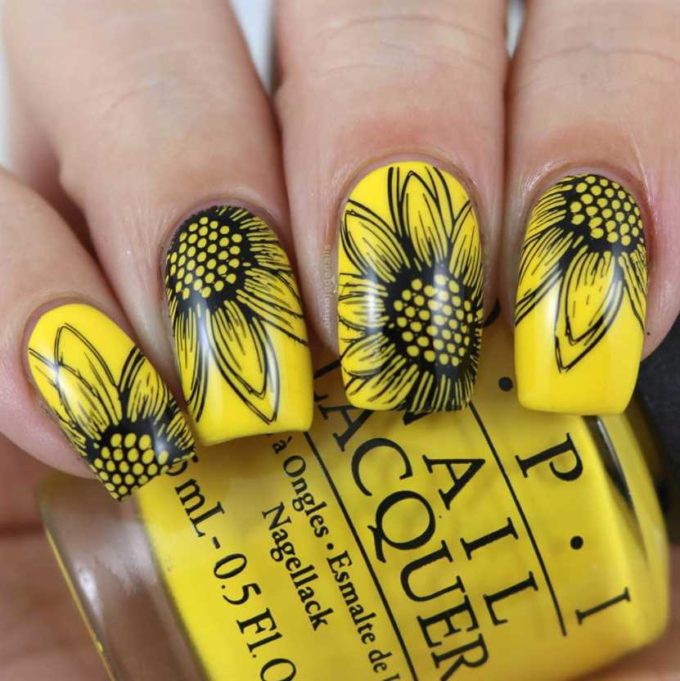 yellow painted with black sunflower drawing nail art