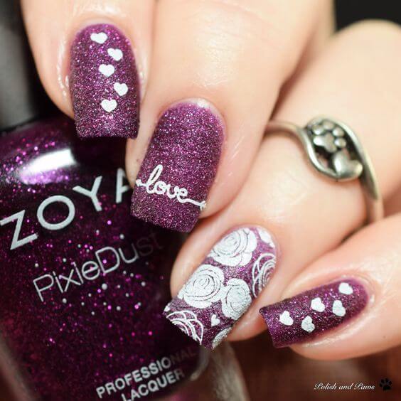 glittery mulberry purple nails with white roses-hearts and love text design idea for valentines day