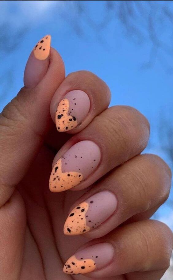 pastel orange french tips with black spots easter nails art  