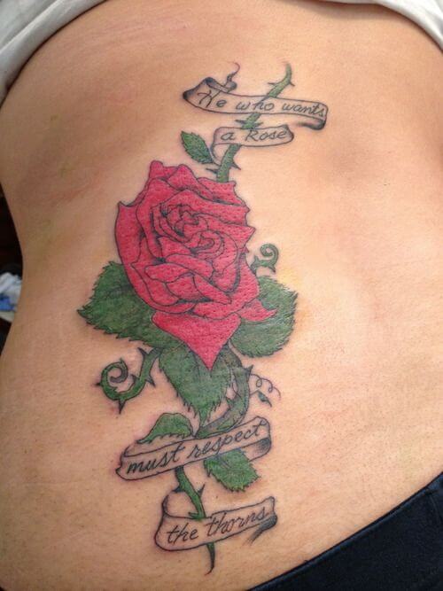banner quote with rose vine tattoo design on side lower back for women