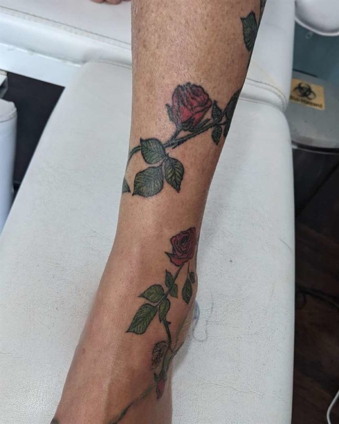 rose vine tattoo wrapped around ankle to foot