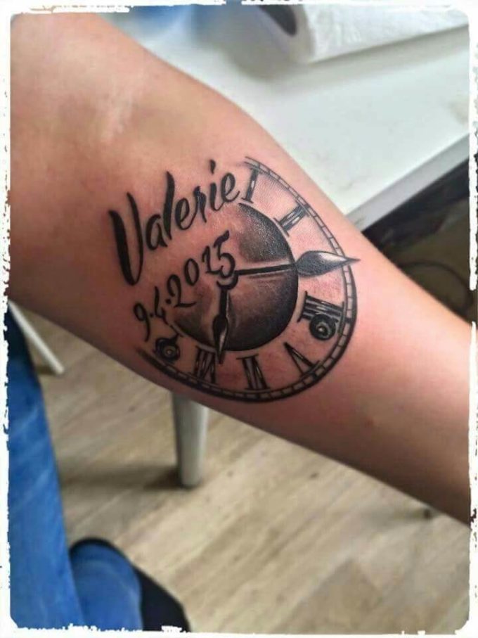 creative half birth clock with name and date tattoo design idea on forearm