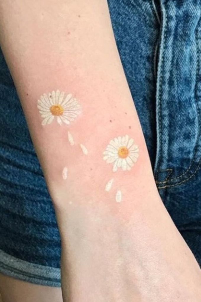 dropping petals daisy april birth flower tattoo designs idea on wrist for females
