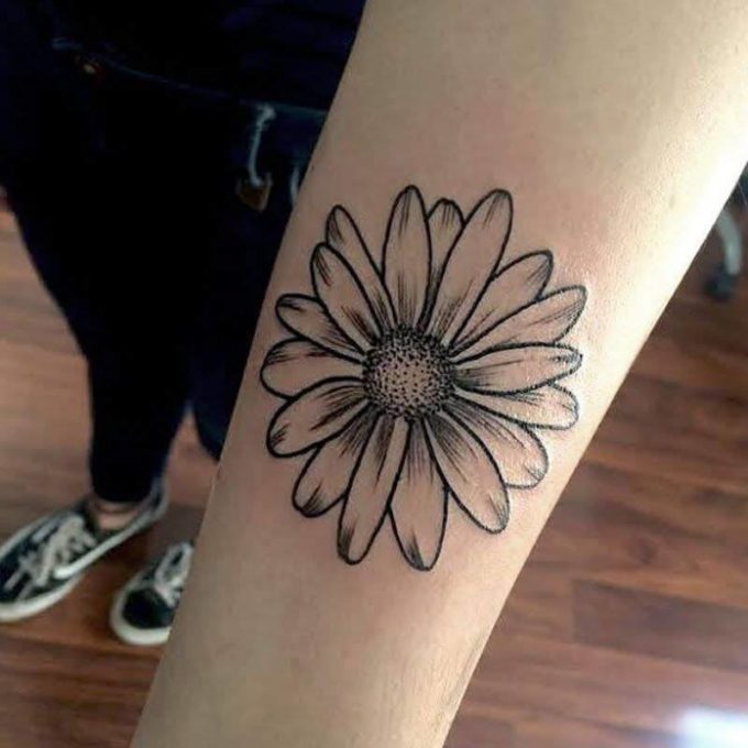 realistic black and white gerbera daisy flower tattoo design idea on forearm