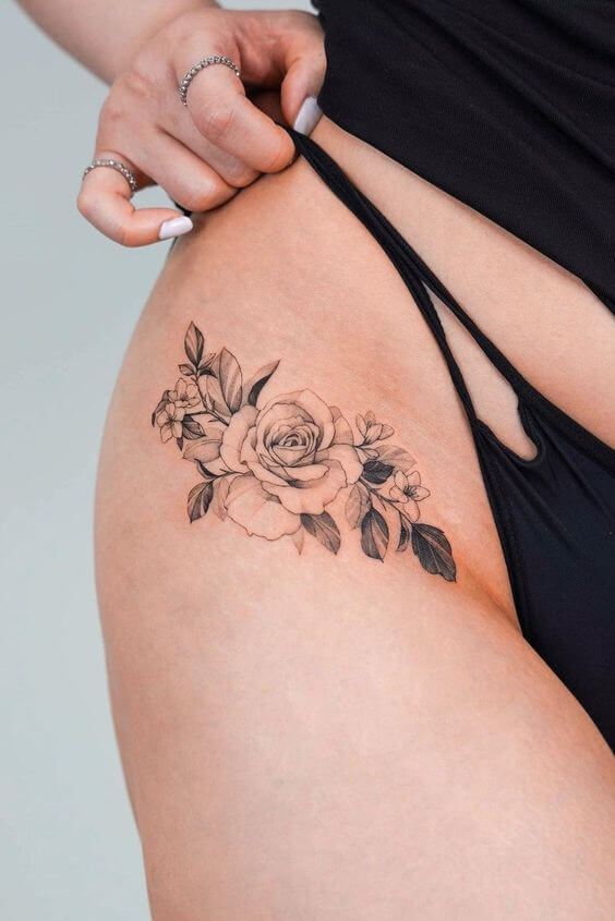 black and white stencil drawing rose june birth flower tattoo design idea on front upper thigh for women