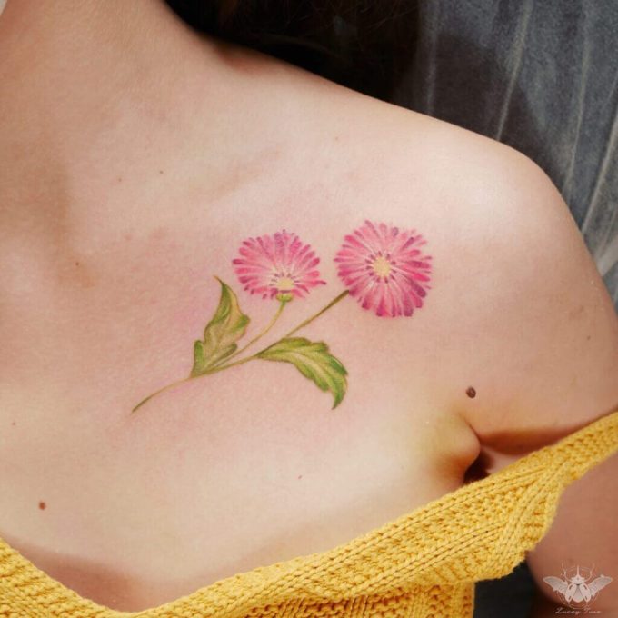 pink gerbera daisy flower tattoos on collarbone for females