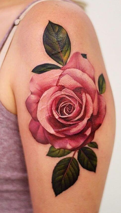 pearly pink rose june birth flower tattoo design idea on upper arm for females