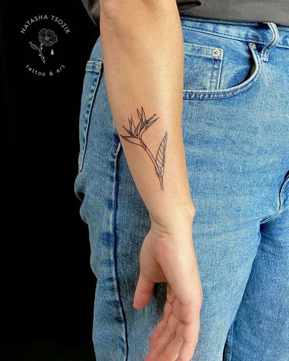 simple side wrist bird of paradise flower tattoo design idea for females