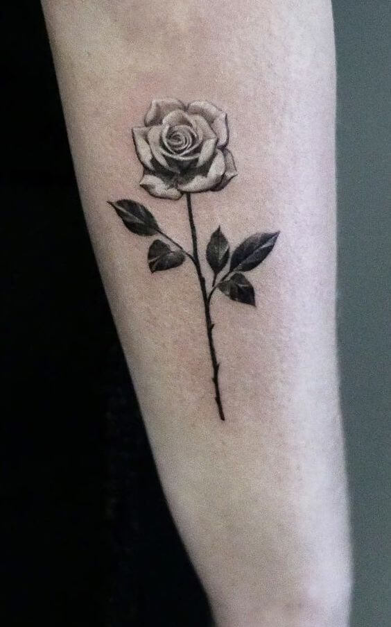 white rose june birth flower tattoo design idea on side arm for females
