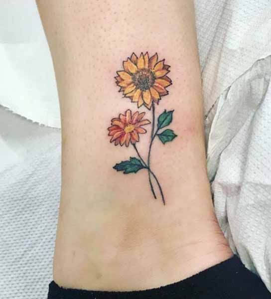 illustrative yellow and orange gerbera daisy flowers tattoo designs on ankle