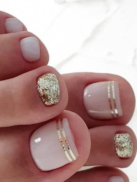 nude with golden stripes and glittery nails art designs idea for 2022