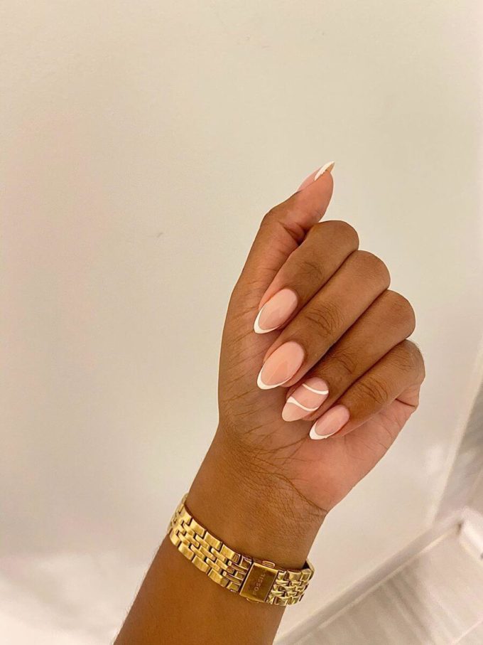 nude french tip with white swirls oval shaped nail art design ideas for 2022