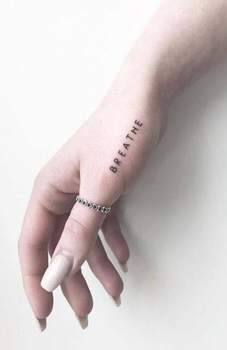 breathe small meaningful word tattoo idea on hand thumb for women