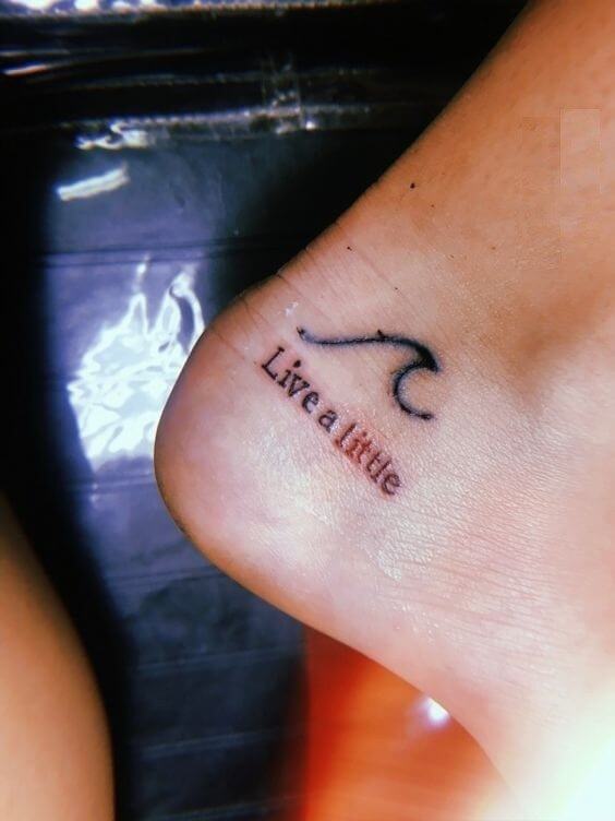wave with live a little quote small meaningful tattoo design idea on heel for females