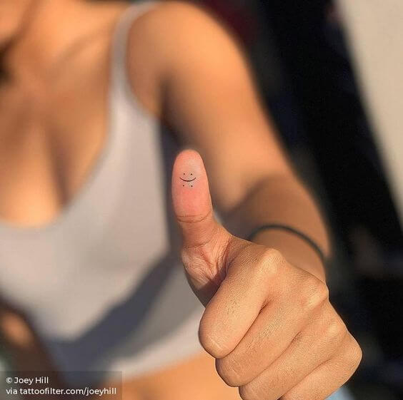 laugh now cry later minimal tattoo design idea on thumb for females