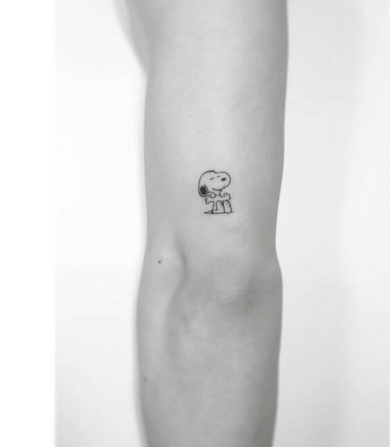 minimal cute happy dog tattoo design idea above elbow 