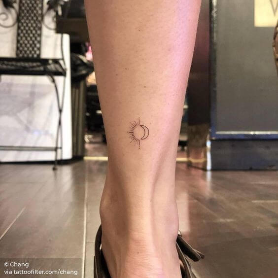 minimal sun and moon tattoo design idea on lower back leg
