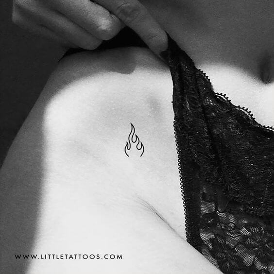 bold minimal fire flame tattoo design idea on v-line for females