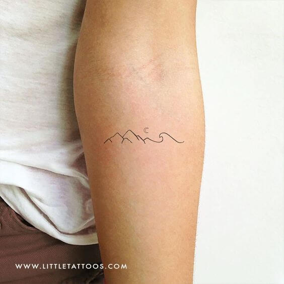 perfect scenery minimal mountains with moon tattoo design idea on forearm for females 