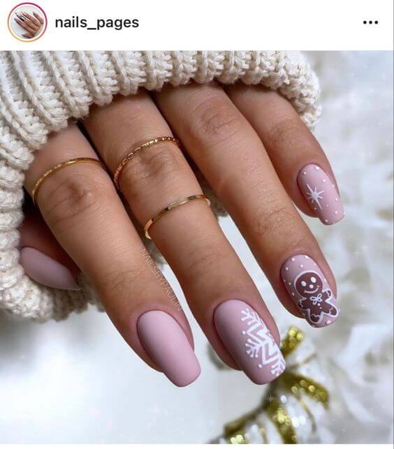 matte baby pink with snowflakes and gingerbread nails art designs idea for christmas holidays