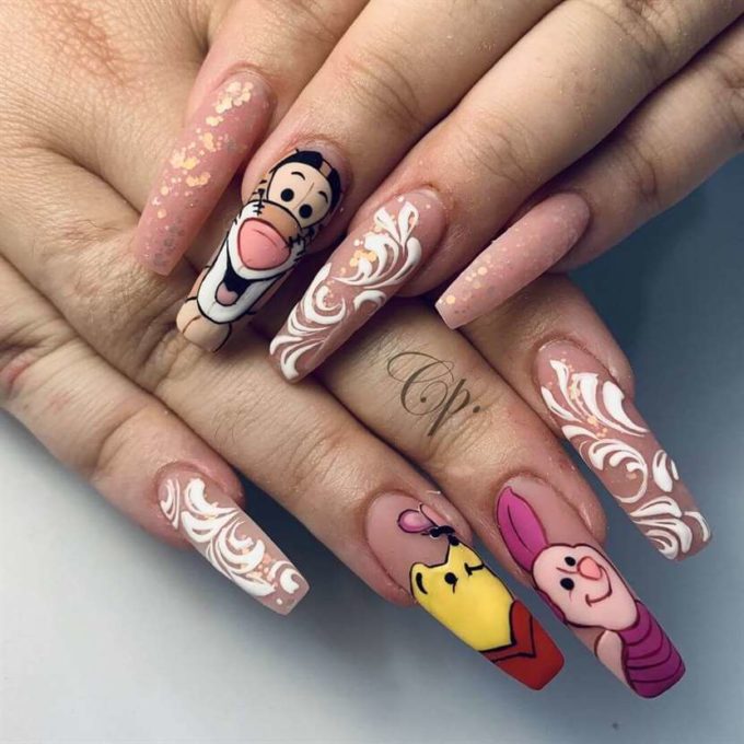 nude with golden glitter-white swirl and winnie the pooh nails art designs idea