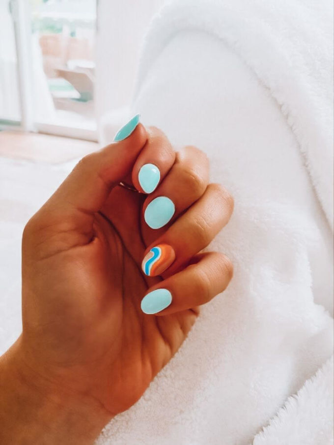 short round matte pastel blue with orange spring break nail art design idea